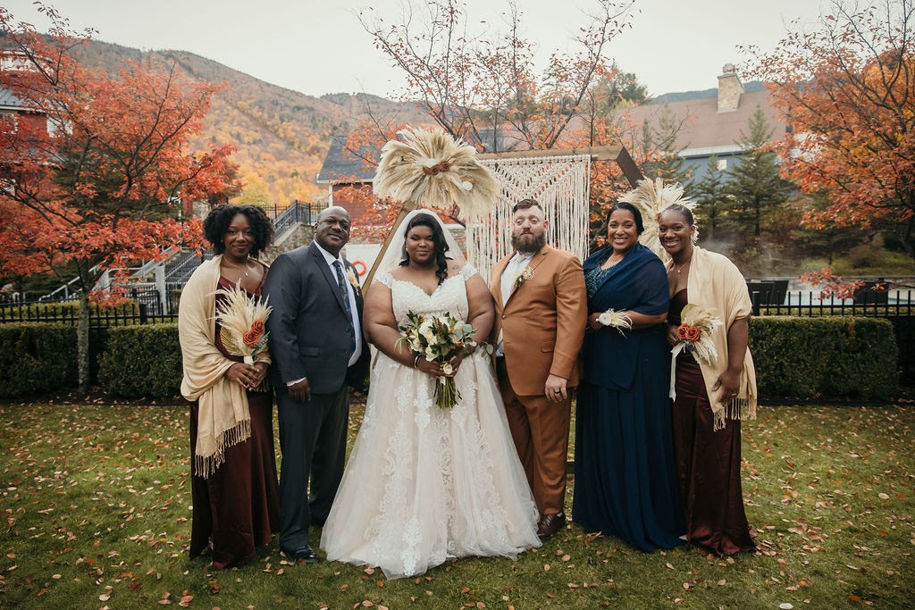 Bride and Groom pose with family 