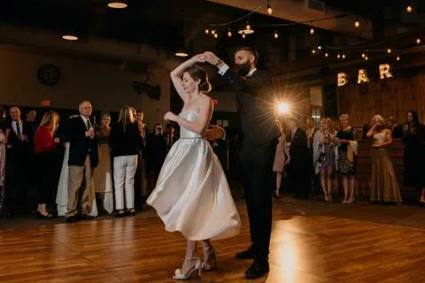 Bride and Groom have first dance under spotlight