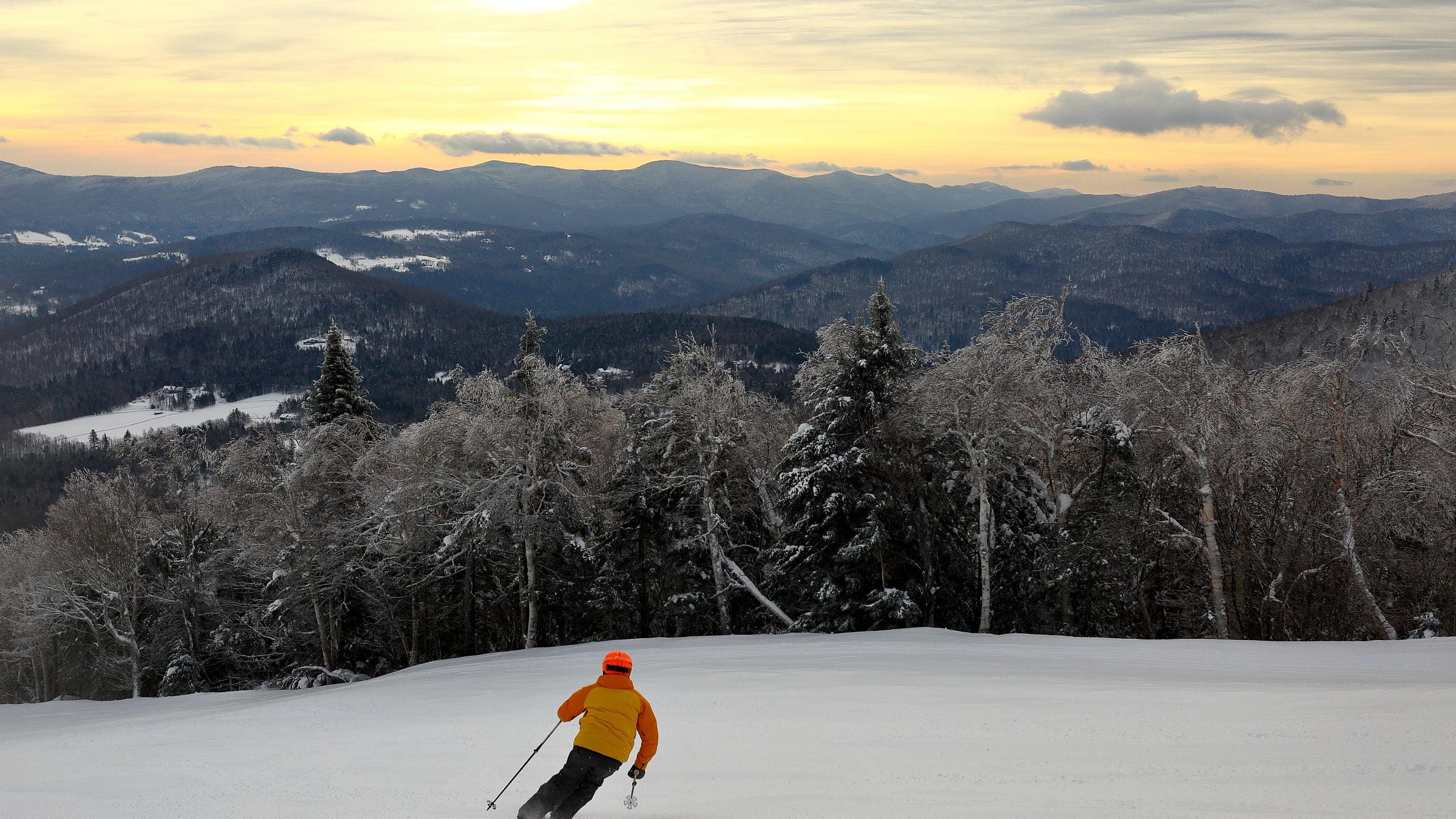 Skier during sunrise powder