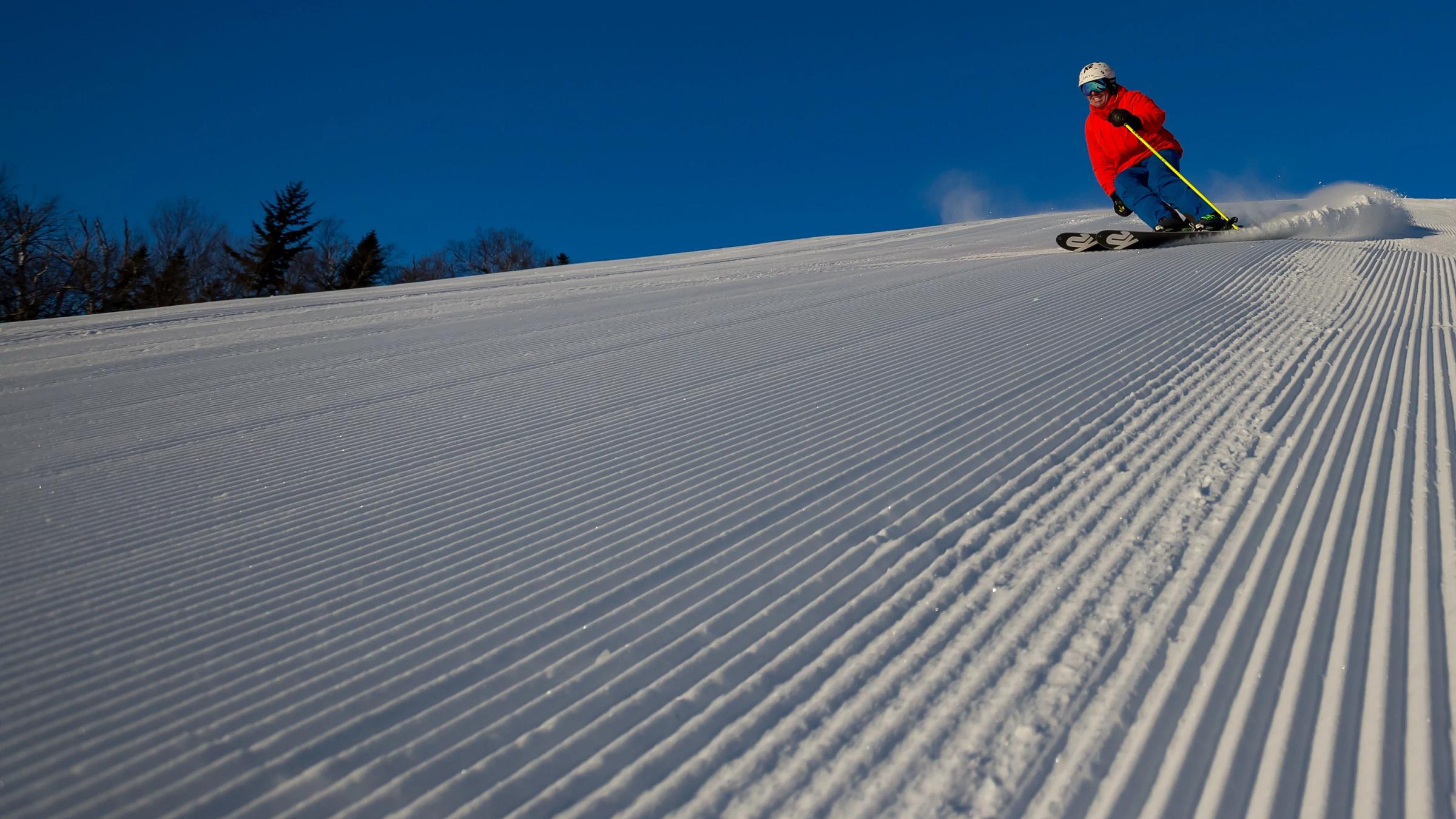 Skier having a blast on a blue day