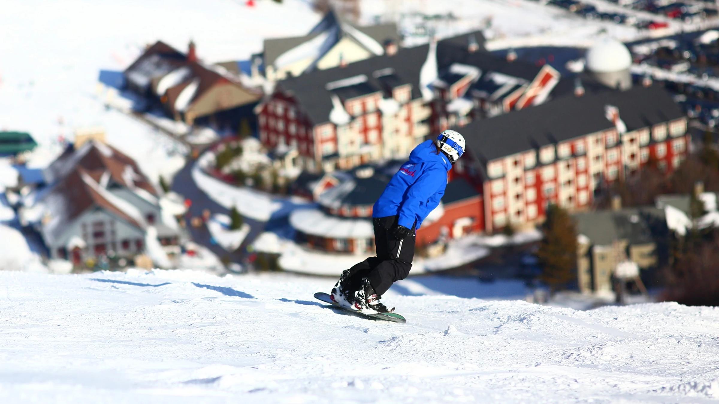 Employee riding down Spring Fling