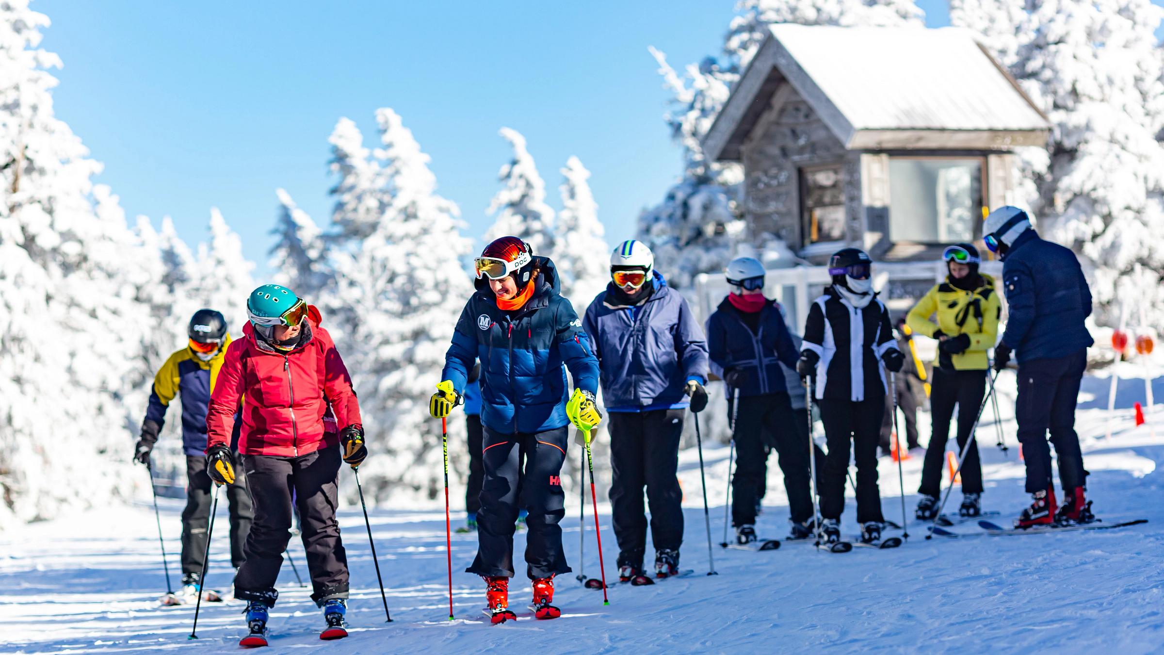 Group of skiers getting off lift