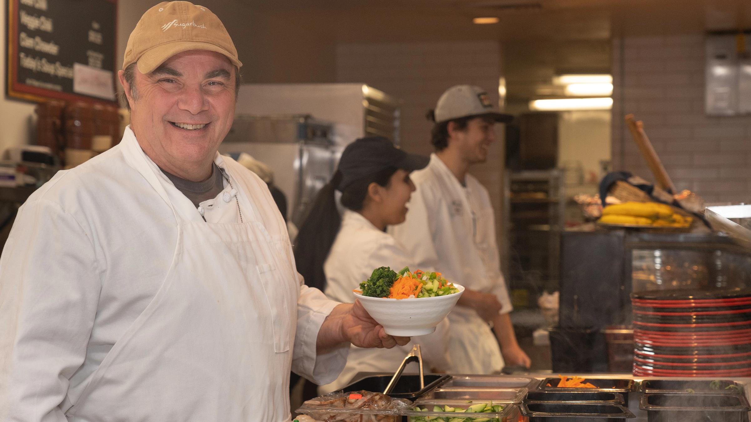 Gatehouse Chef holding a salad