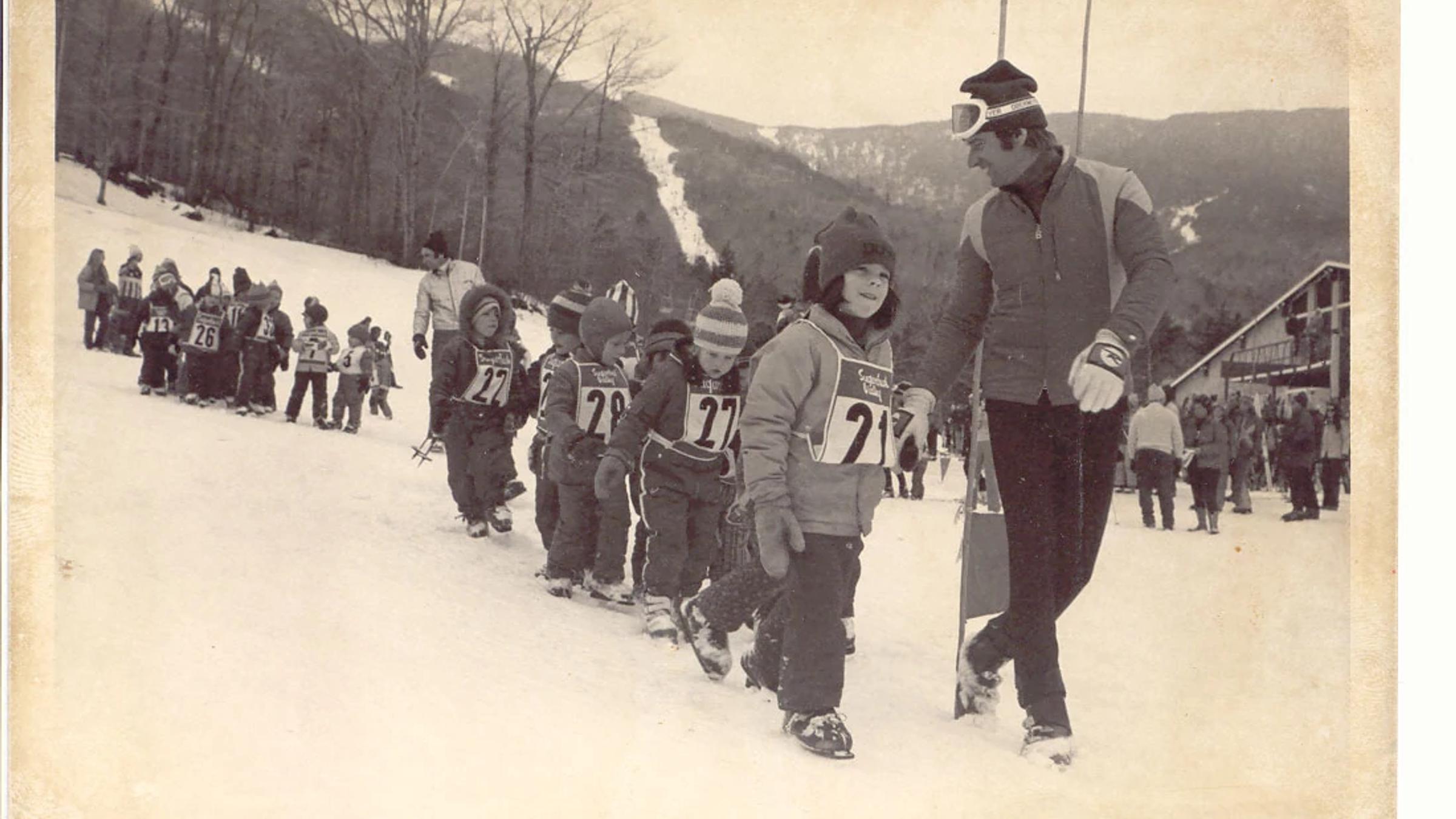 Group of young children going to ski school