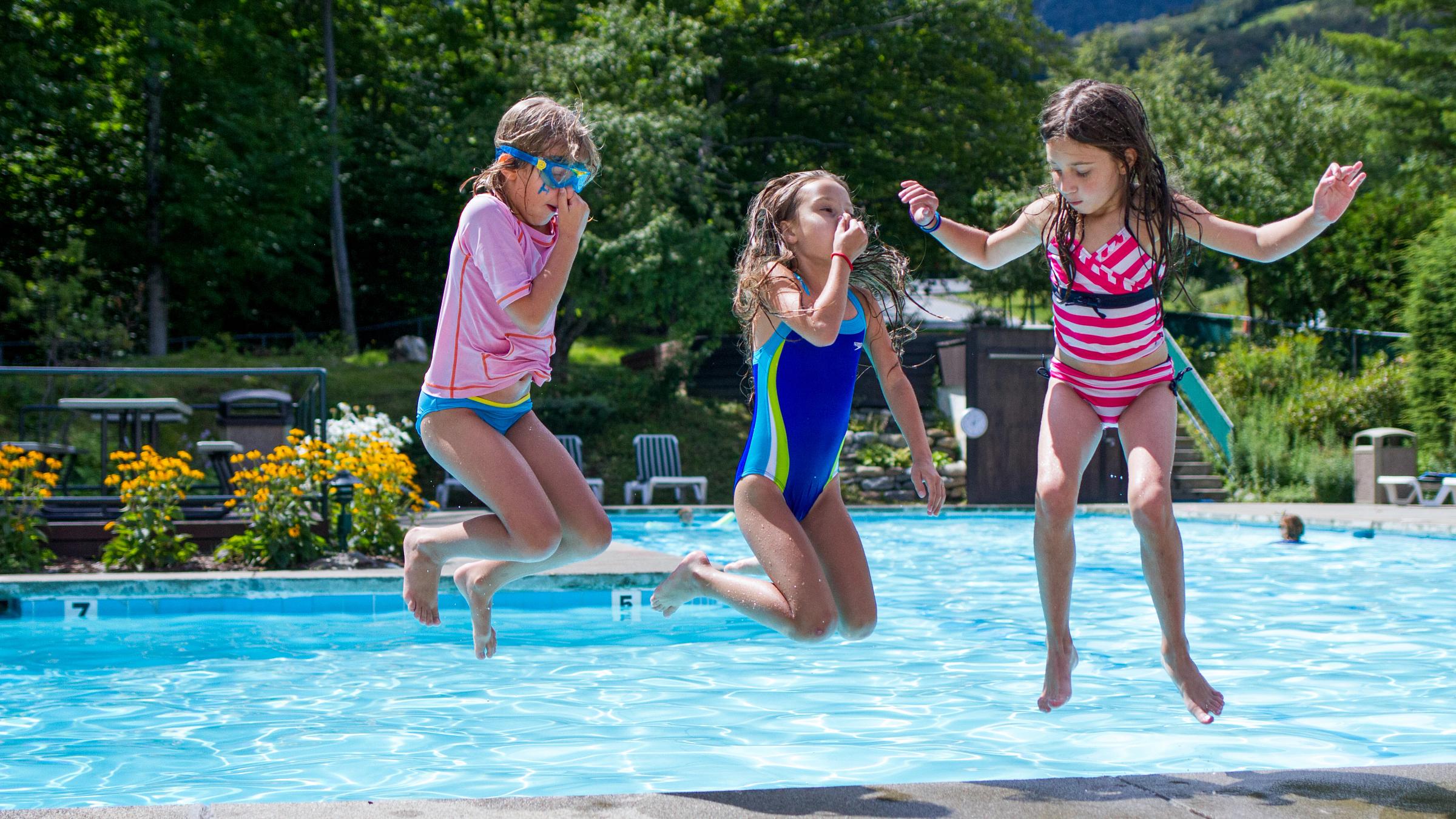 Kids jumping into the pool
